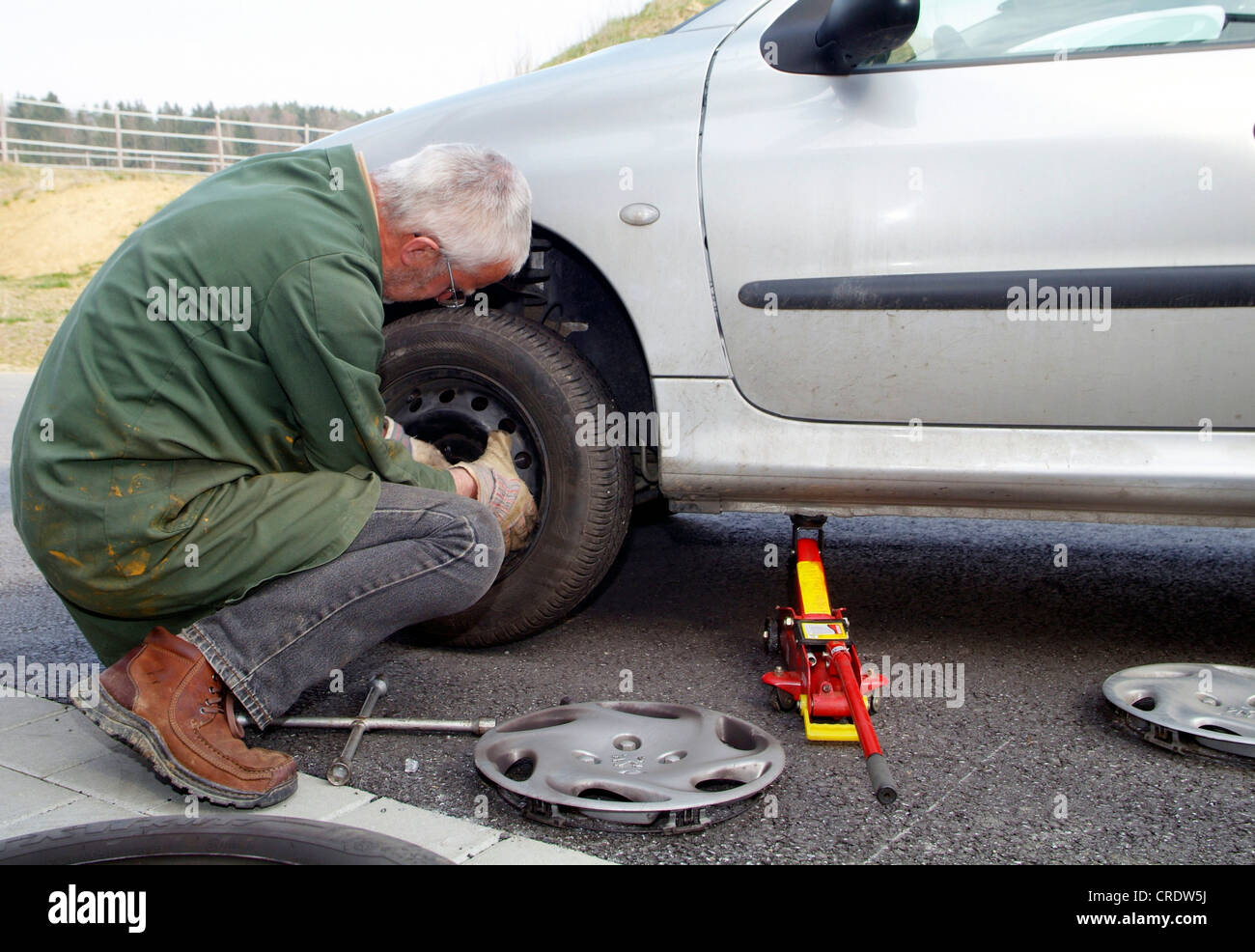 man during tire change Stock Photo