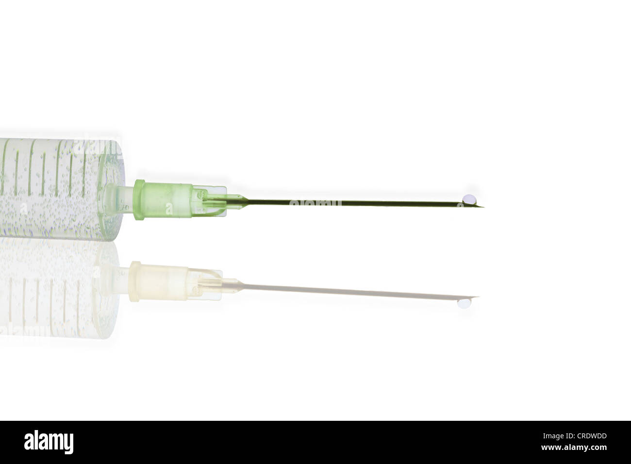 Syringe with a hypodermic needle and a droplet Stock Photo