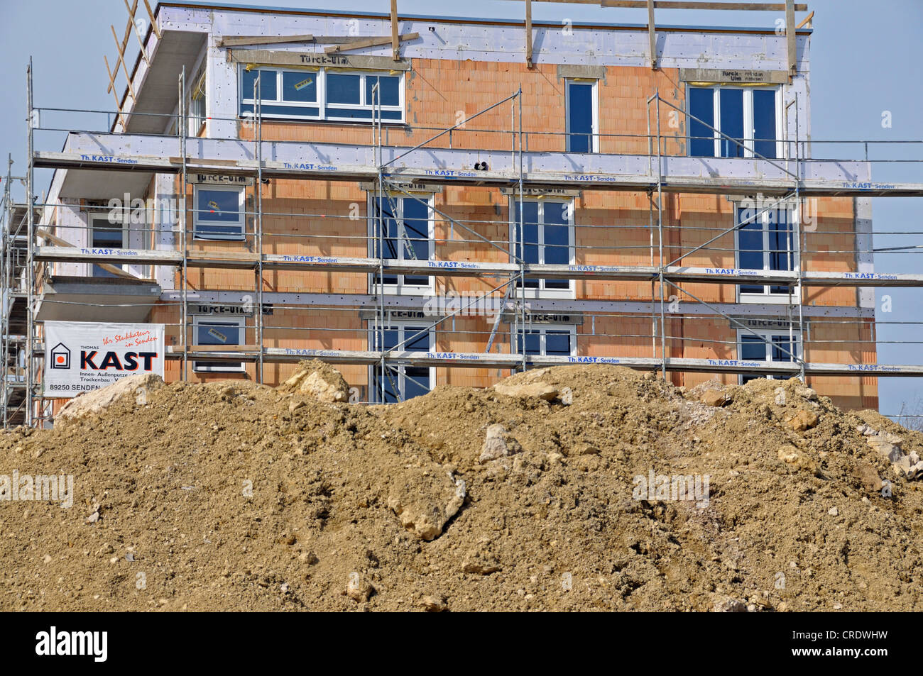 Earth bank in front of a scaffolded building under construction, apartment house, Ulm, Baden-Wuerttemberg, PublicGround Stock Photo