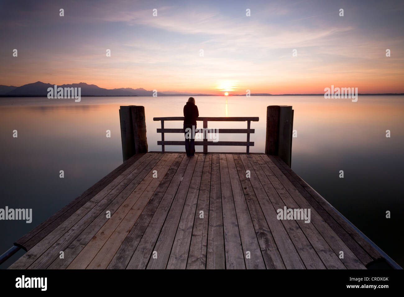 Woman on a dock in the evening light near Chieming on Lake Chiemsee, Bavaria, Germany, Europe, PublicGround Stock Photo