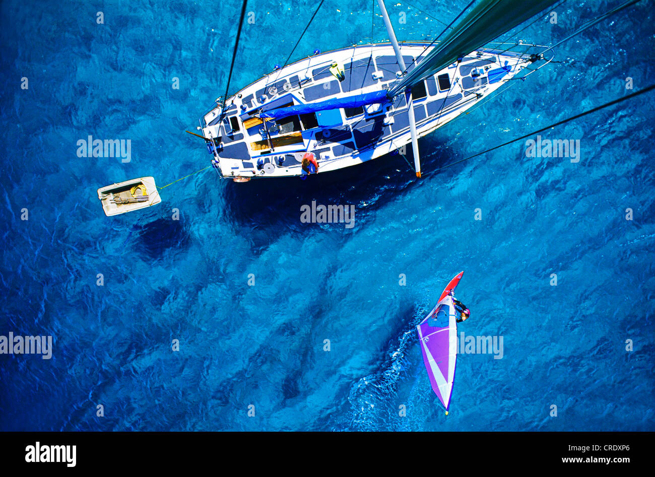 view from a boat mast on a sailing ship and a windsurfer Stock Photo
