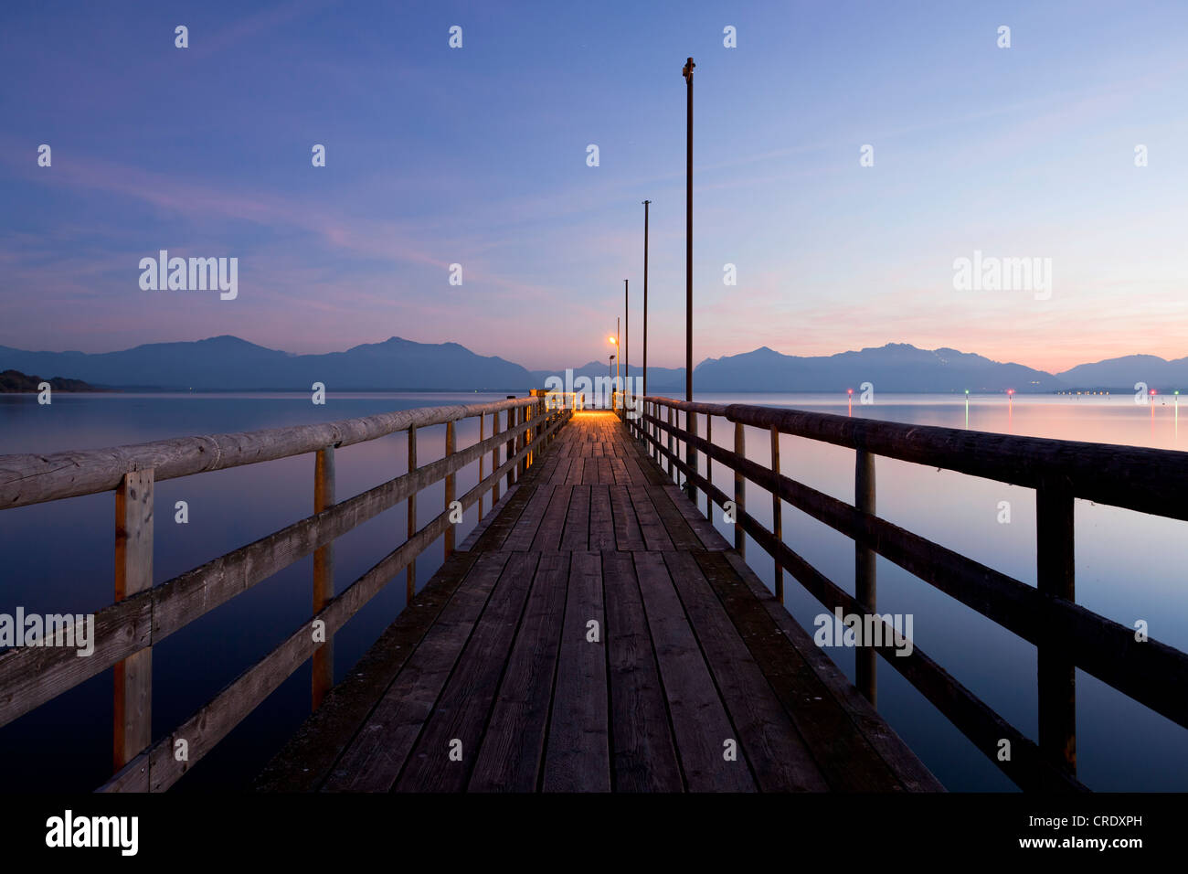 Jetty in Seebruck on Chiemsee lake overlooking the Chiemgau Alps at dusk, Bavarian Alps, Bavaria, Germany, Europe, PublicGround Stock Photo
