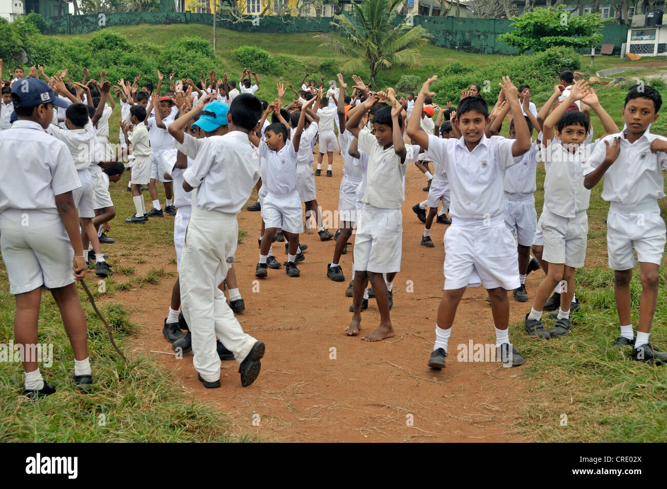 Boys wearing white uniforms during sports lessons, Galle, Sri Lanka, Asia Stock Photo