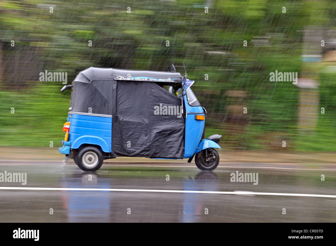Tuk tuk or trishaw driving though heavy rain, Sri Lanka, Ceylon, South Asia, Asia Stock Photo