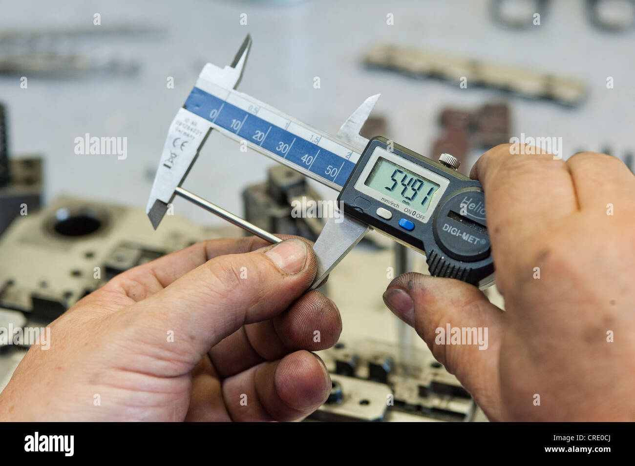 Taking a measurement with calipers, tool production Stock Photo