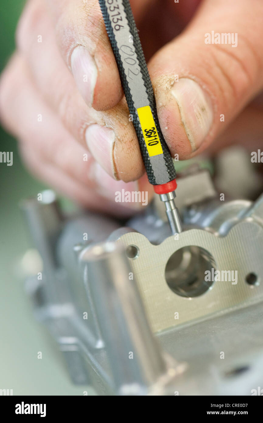 Measuring a drilled hole with a gauge, measuring instrument Stock Photo