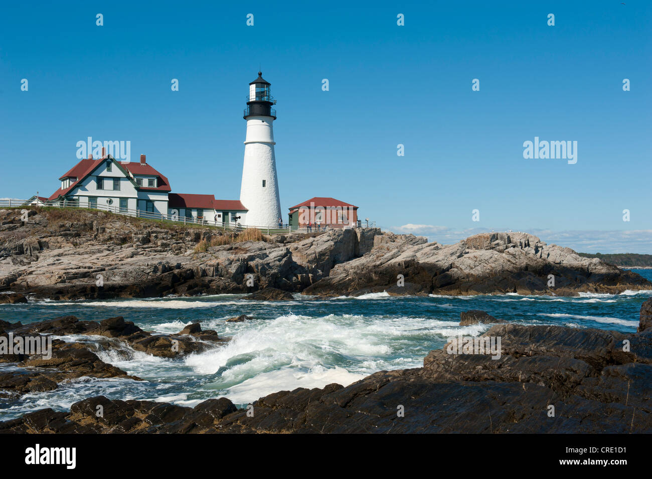 White lighthouse, waves breaking on rocks, Portland Head Light, Portland, Cape Elizabeth, Maine, New England, USA, North America Stock Photo