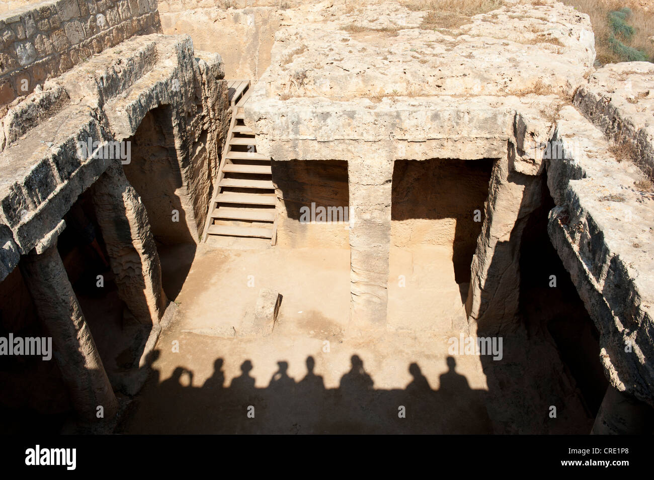 Shadows of tourists on a study trip, looking down into a tomb, Royal Tombs, archaeology, Paphos, Pafos, Cyprus, Europe Stock Photo