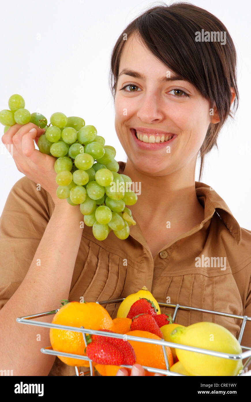 young woman eats grapes Stock Photo Alamy