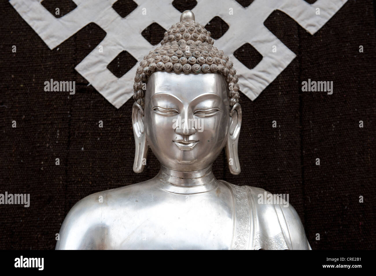 Tibetan Buddhism, silver Buddha statue, symbol of the endless knot or eternal knot, Jokhang Temple, Lhasa, Himalayas, Tibet Stock Photo