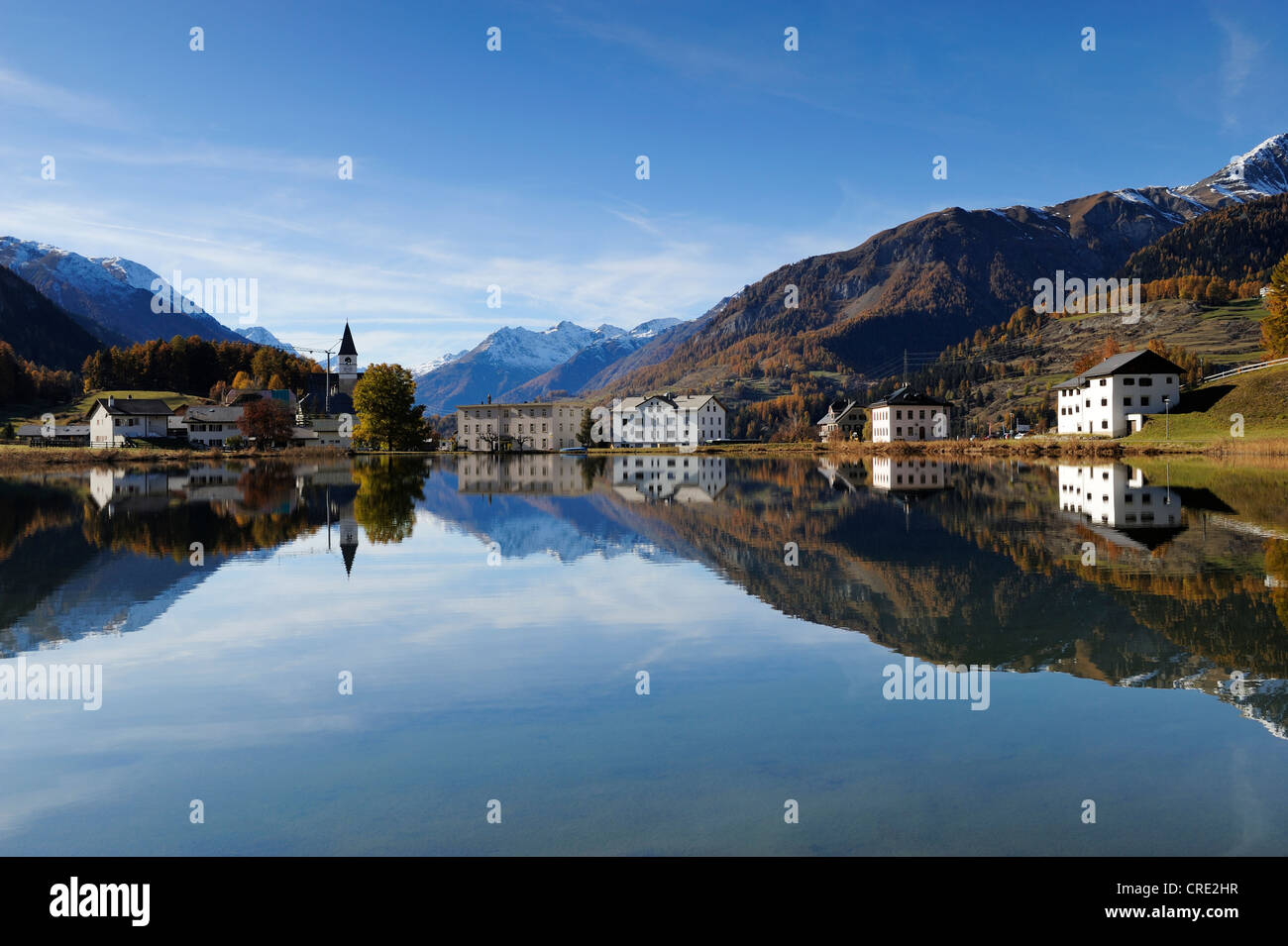 Lake Tarasp with a reflection of the villiage of Tarasp, Scuol, Lower Engadin, Grisons, Switzerland, Europe Stock Photo