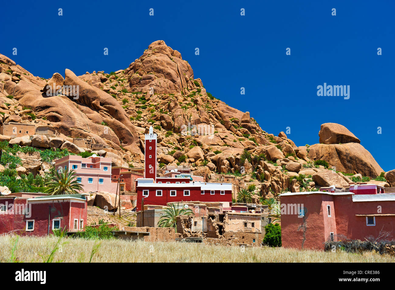 Houses and a mosque with a minaret in typical rocky landscape of granite boulders, Tafraoute, Anti-Atlas Mountains Stock Photo