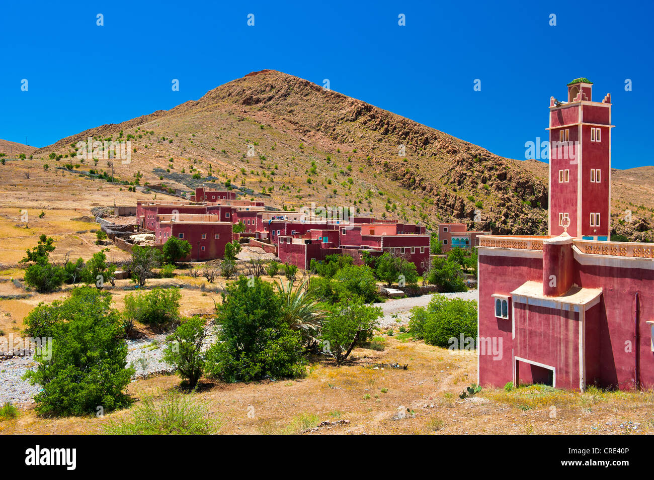 Mosque with a minaret and small town on a dry river bed in the Anti-Atlas Mountains, southern Morocco, Morocco, Africa Stock Photo