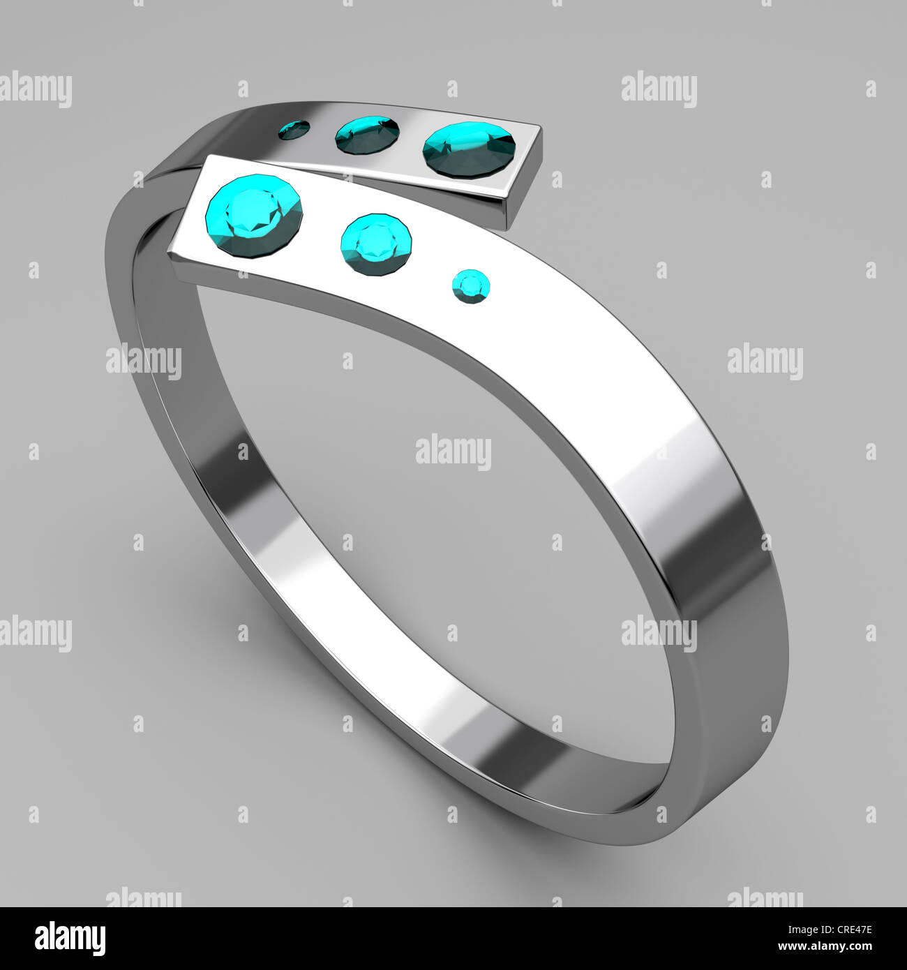 Silver ring with turquoise diamonds on gray background Stock Photo