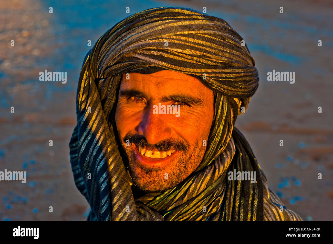 Portrait, friendly Berber man wearing a black and gold turban in the evening light, Merzouga, southern Morocco, Morocco, Africa Stock Photo