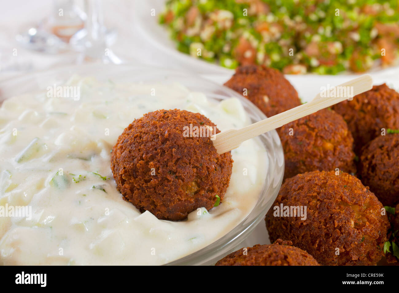 Homemade falafel served with tzatziki and tabbouleh. Stock Photo