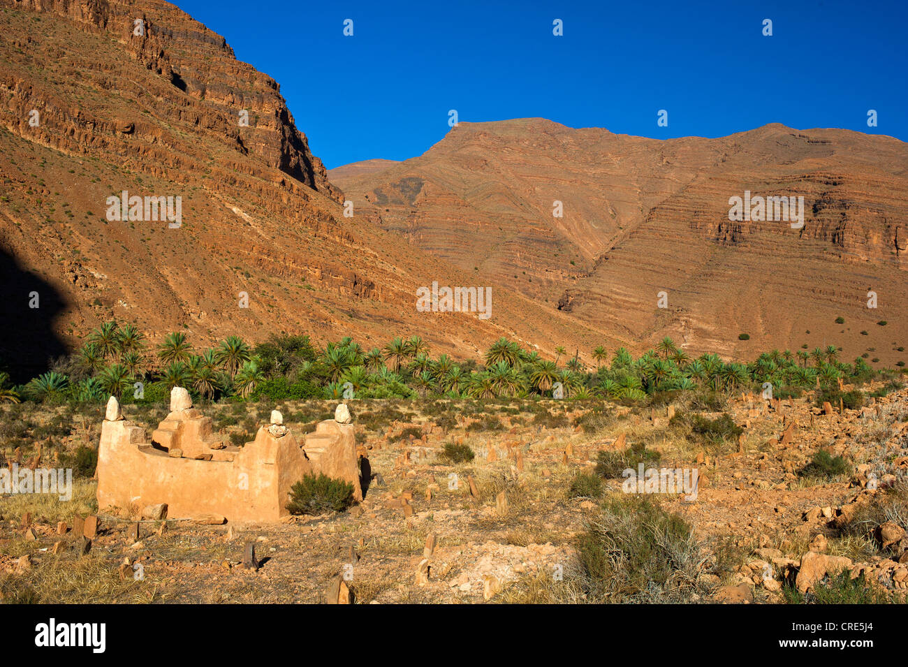 Mountain landscape in the valley of Ait Mansour, Islamic cemetery and a walled-in grave, Anti-Atlas mountain range Stock Photo