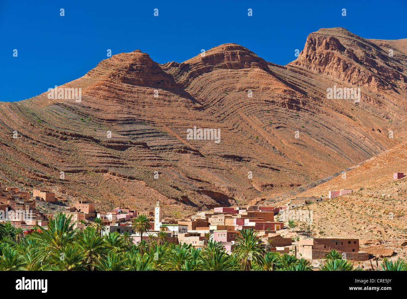 Typical cuesta landscape, mountain slopes characterized by erosion, with small settlements and date palms, Ait Mansour valley Stock Photo