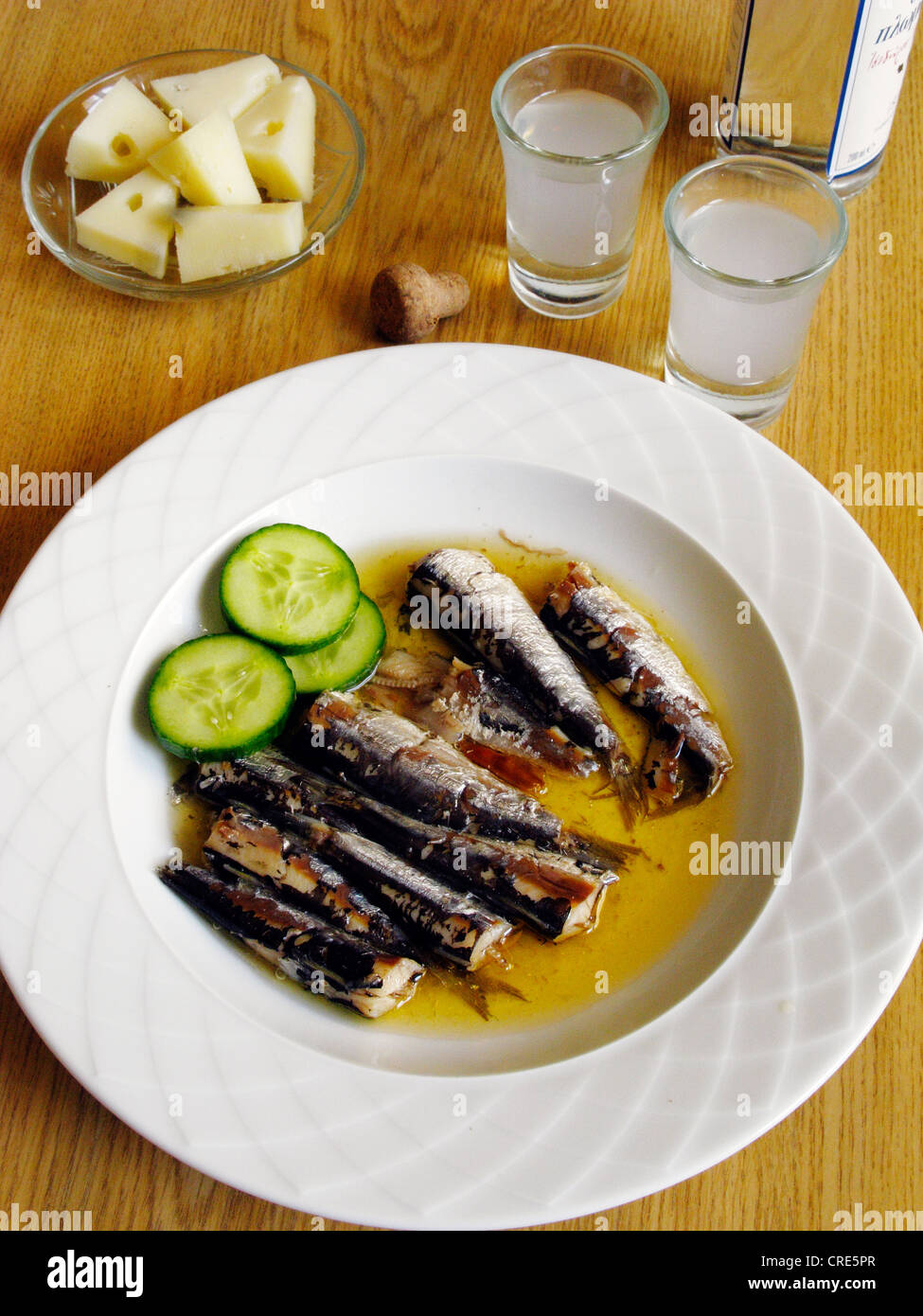 Greek Cuisine. Sardines in Olive Oil Meze with Ouzo and Cheese Stock Photo