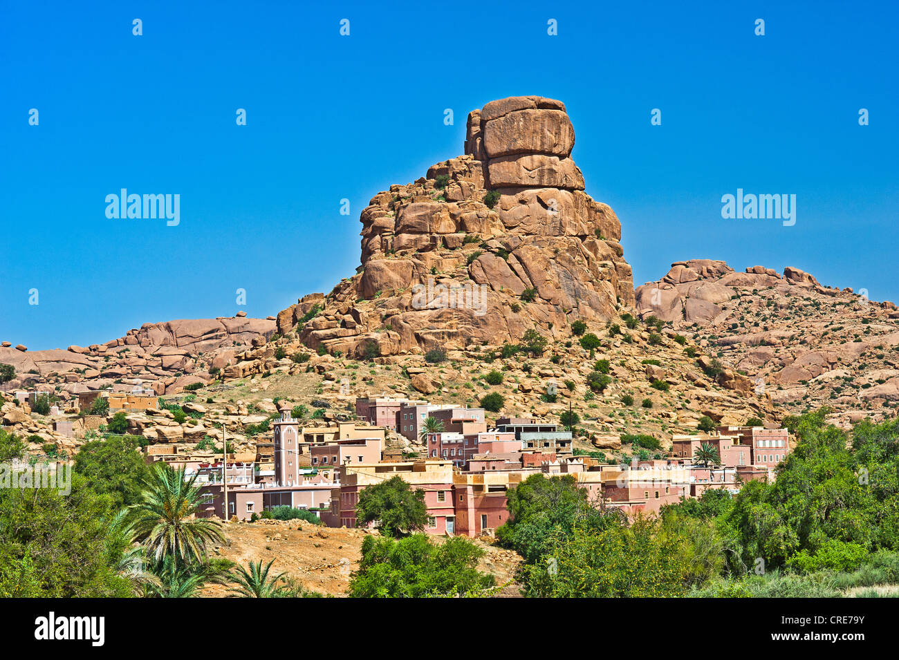 Small village of Aguard Ouda with a mosque in front of the Chapeau Napoleon or Napoleon's hat rock formation, Tafraoute Stock Photo