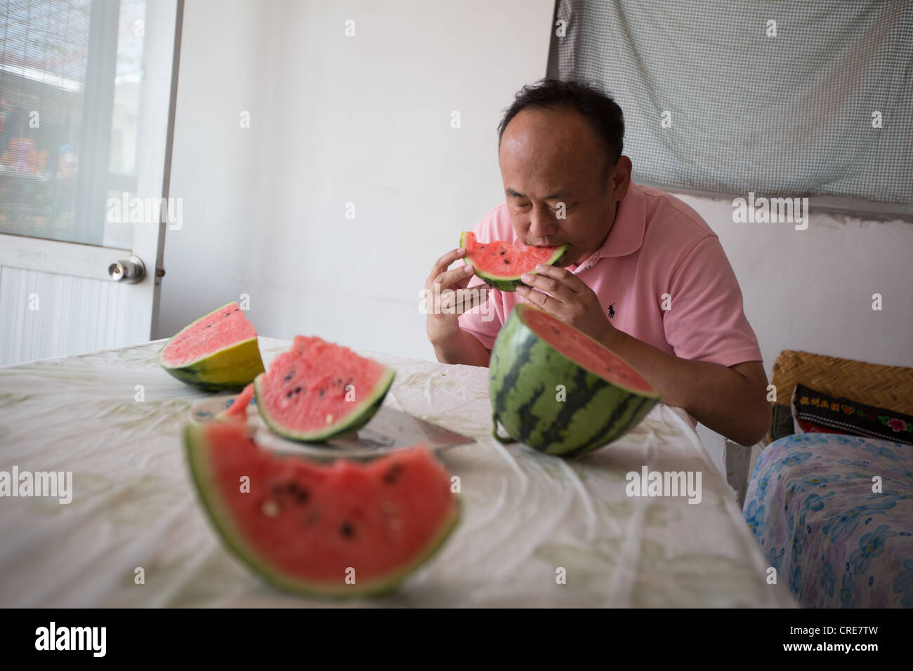 CHinese man eating watermelon, in Daxing, near Beijing, China Stock