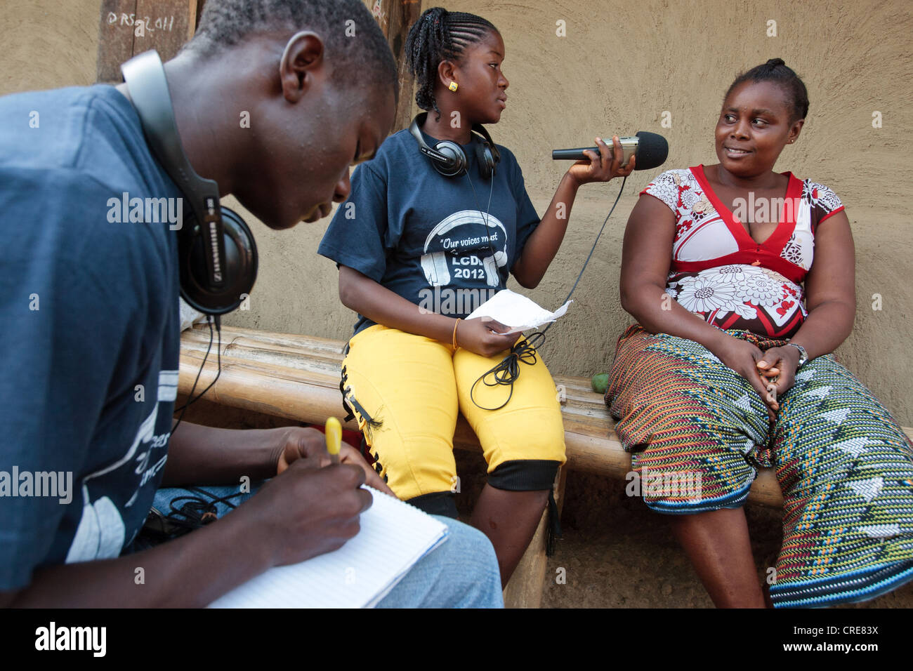 Satta Fahnbulleh, 17, interviews a woman while Karn B. Sherman, 17, takes notes as they work on producing a radio show Stock Photo