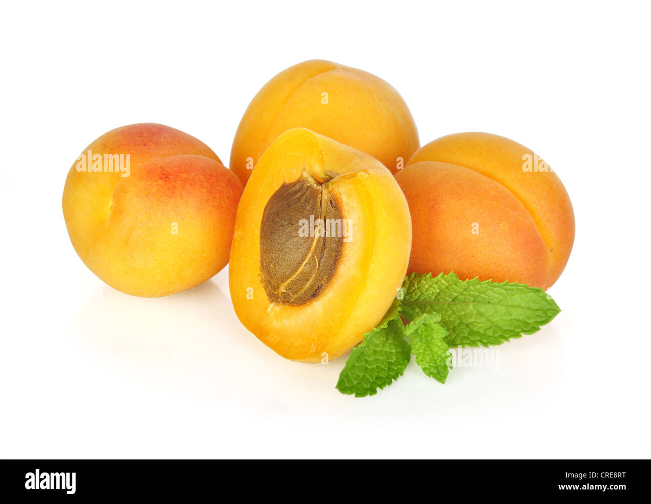 Some apricots with leaves isolated on white background Stock Photo - Alamy