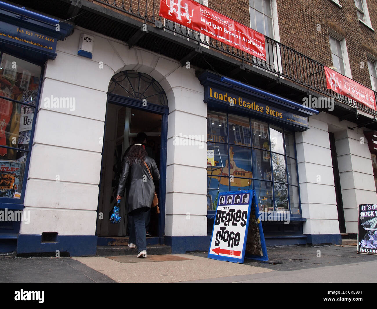 Beatles fan walking into the Beatles store on Baker Street in London, England, May 15, 2012, © Katharine Andriotis Stock Photo
