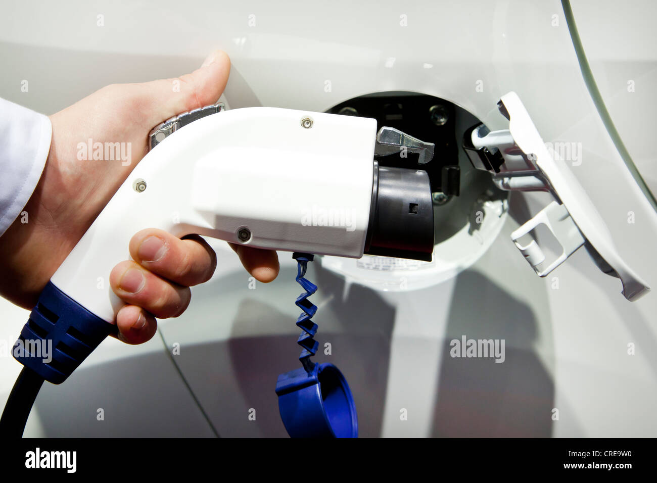 Charging with a 230 volt plug, pistol grip charger, on an electric car, 64th International Motor Show, IAA, 2011 Stock Photo