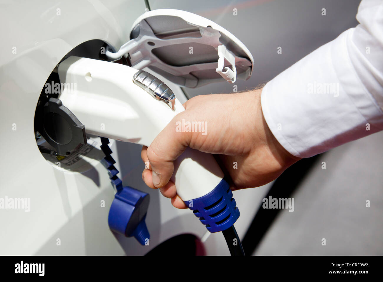Charging with a 230 volt plug, pistol grip charger, on an electric car, 64th International Motor Show, IAA, 2011 Stock Photo