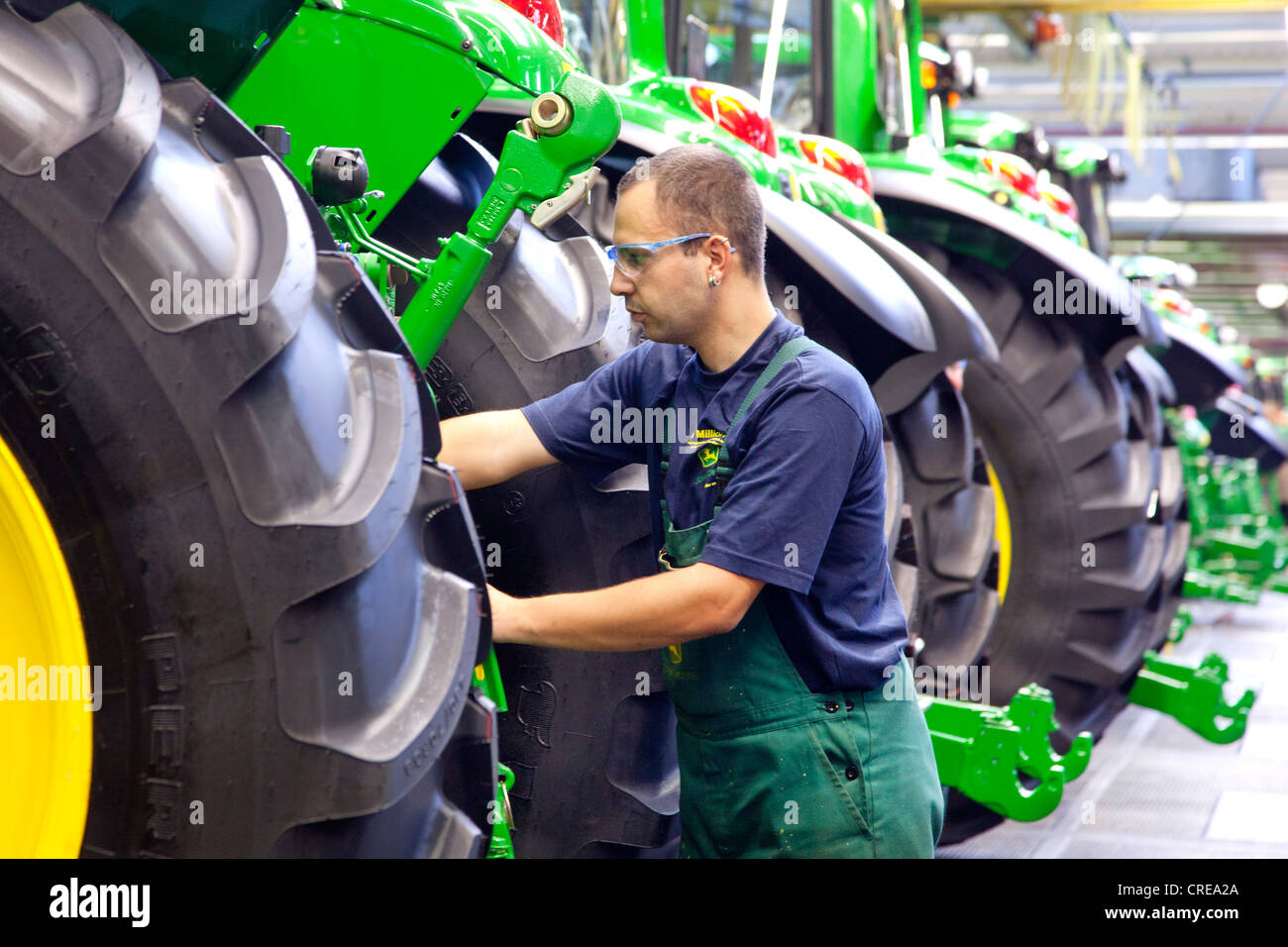 Wheels are mounted in the tractor production section at the European headquarters of the American agricultural machinery Stock Photo