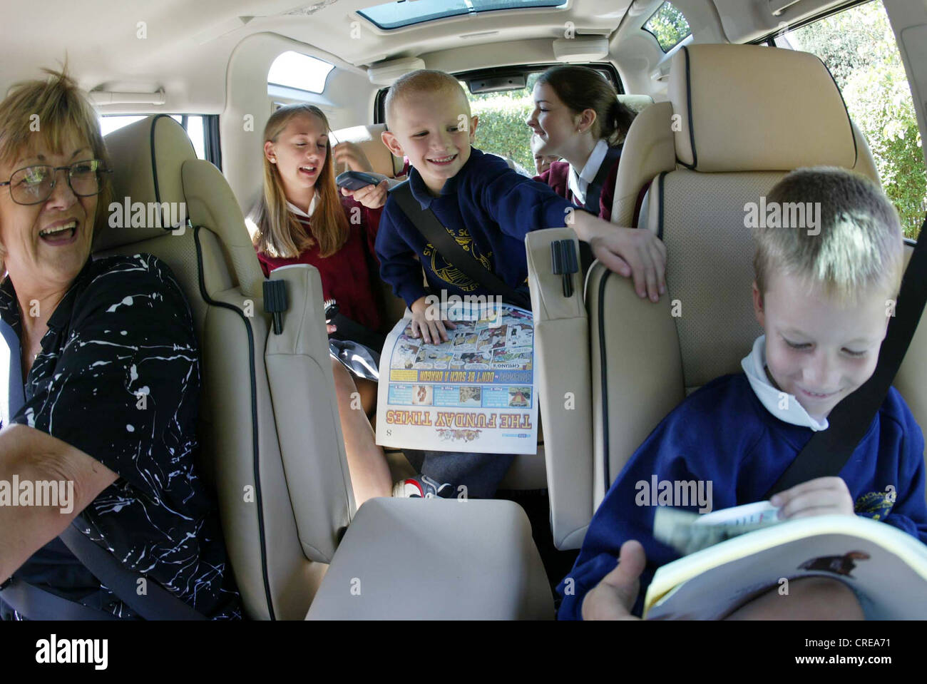 Parent driving car for early morning children's schoolrun, Sussex, United Kingdom Stock Photo