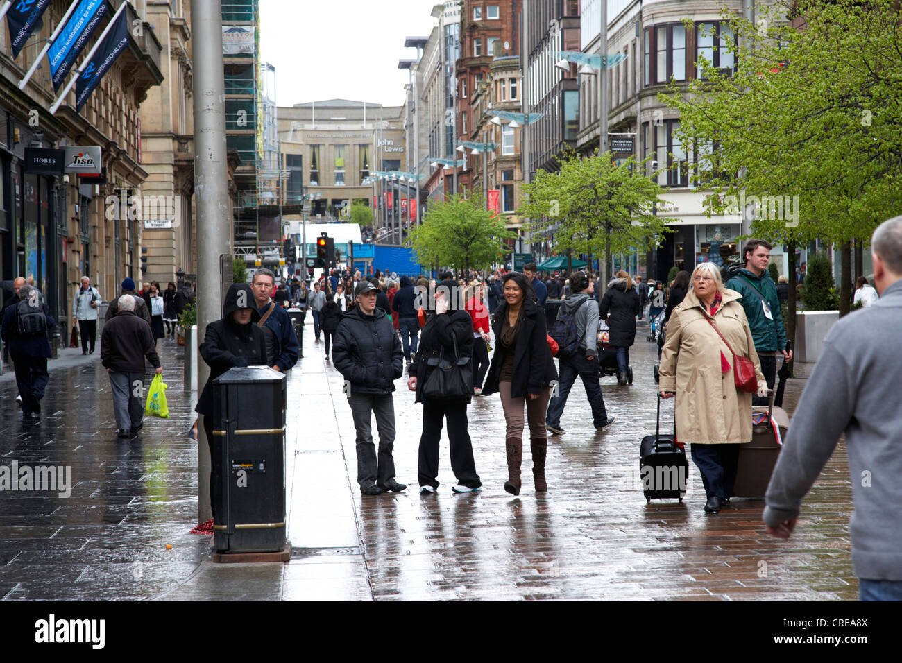 tourists and shoppers on buchanan st shopping street glasgow on a wet rainy day in scotland uk Stock Photo