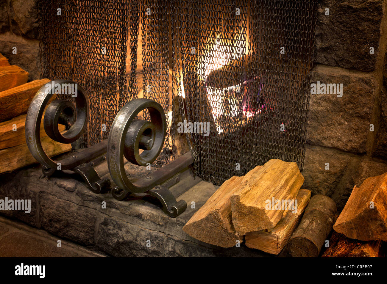 Fire in fireplace with wrought iron grate. Timberline Lodge, Oregon Stock Photo