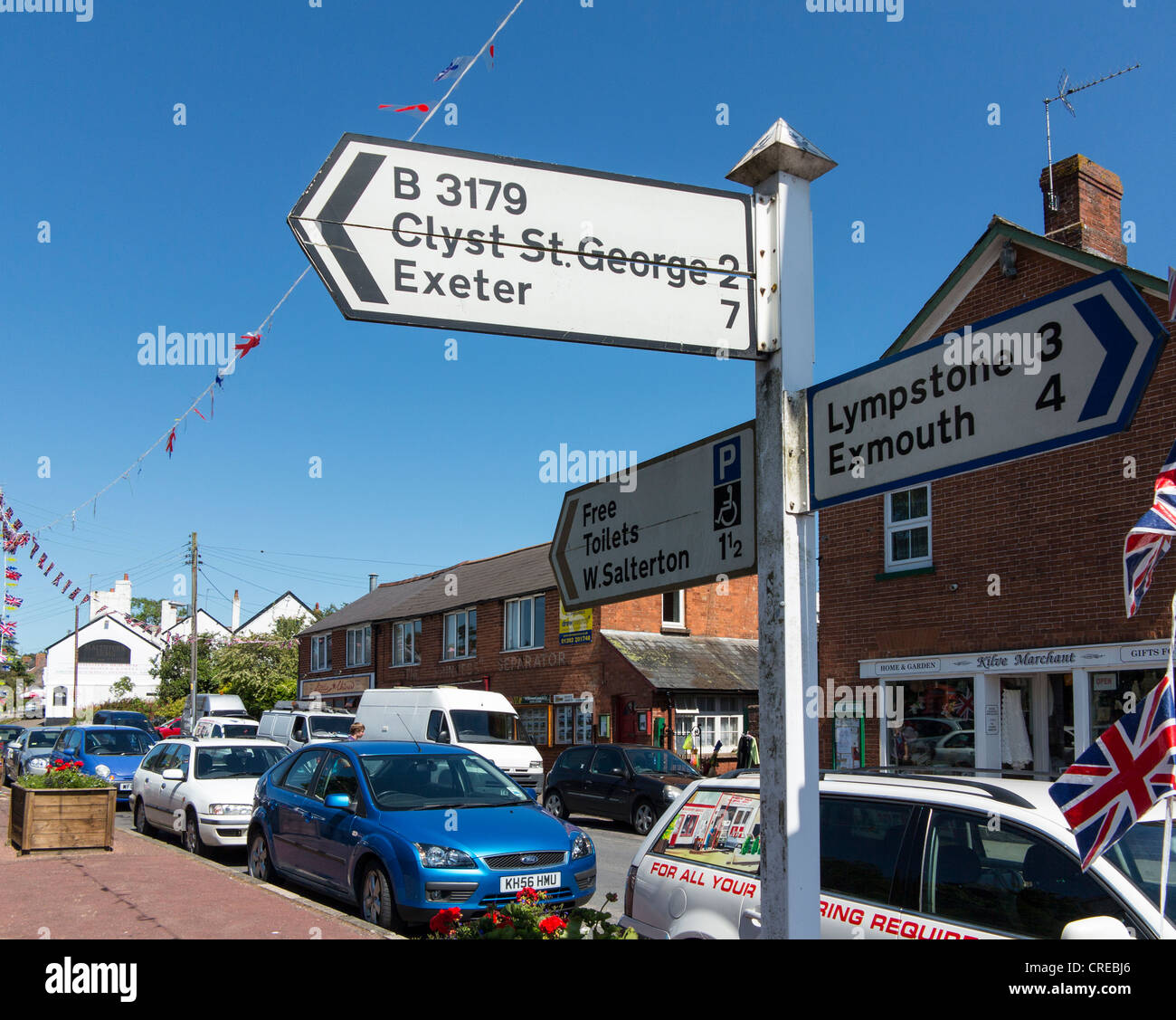signpost-and-jubilee-union-flags-in-the-village-of-woodbury-devon
