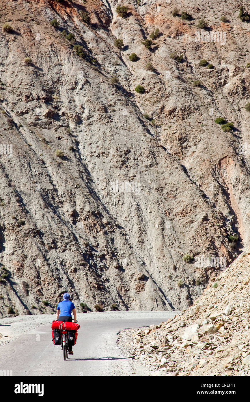 Female cyclist, Tizi-n-Test mountain pass, Tizi-n-Test mountain pass road in the High Atlas Mountains near Asni, Morocco, Africa Stock Photo