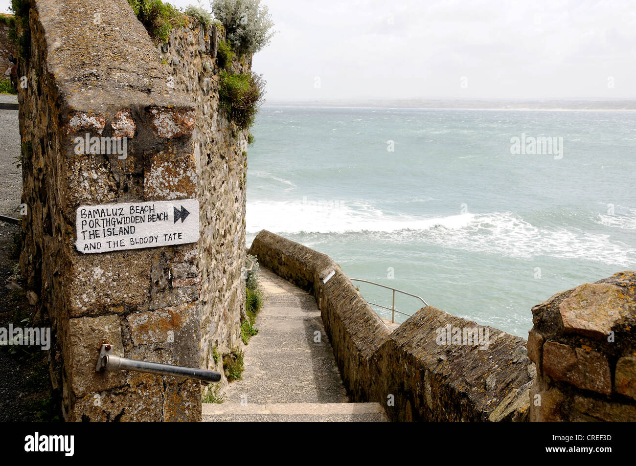 Steps on the sea wall in St Ives Cornwall with a sign showing the way to the Tate gallery Stock Photo