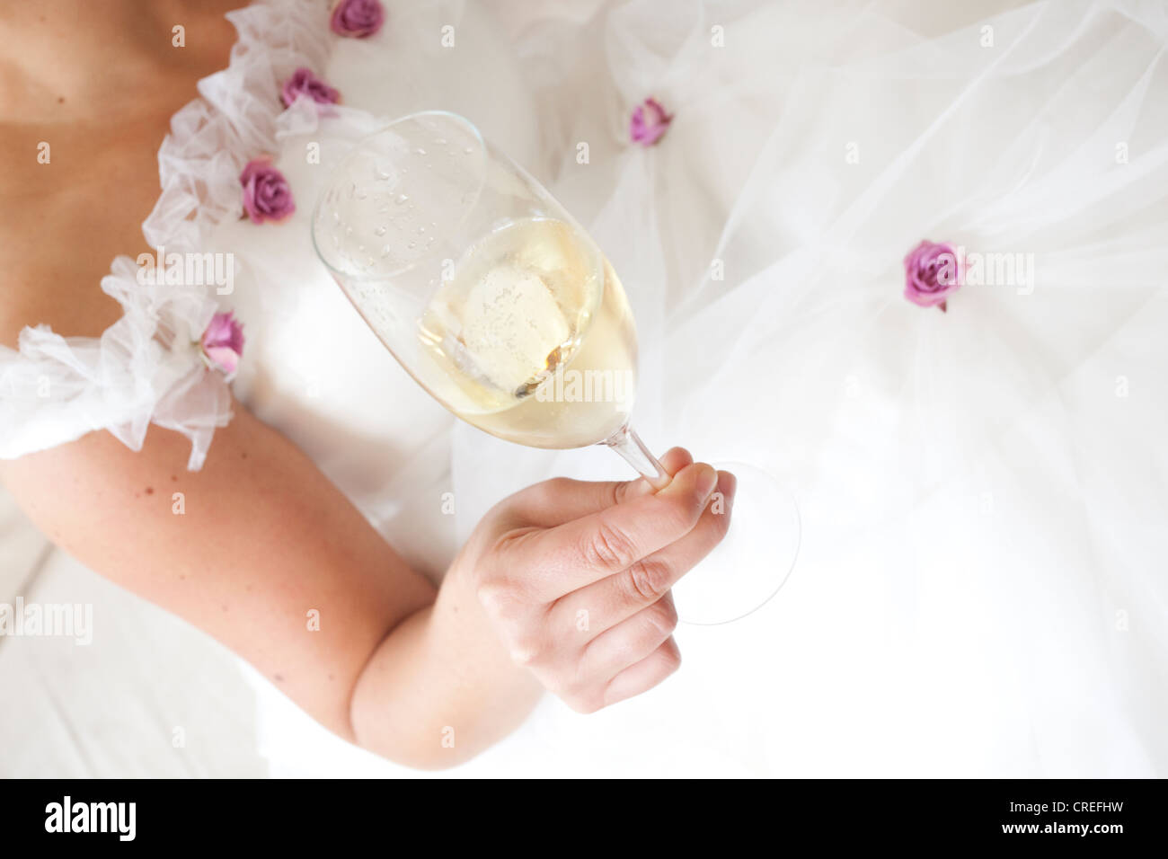 Bride drinking a glass of champagne Stock Photo