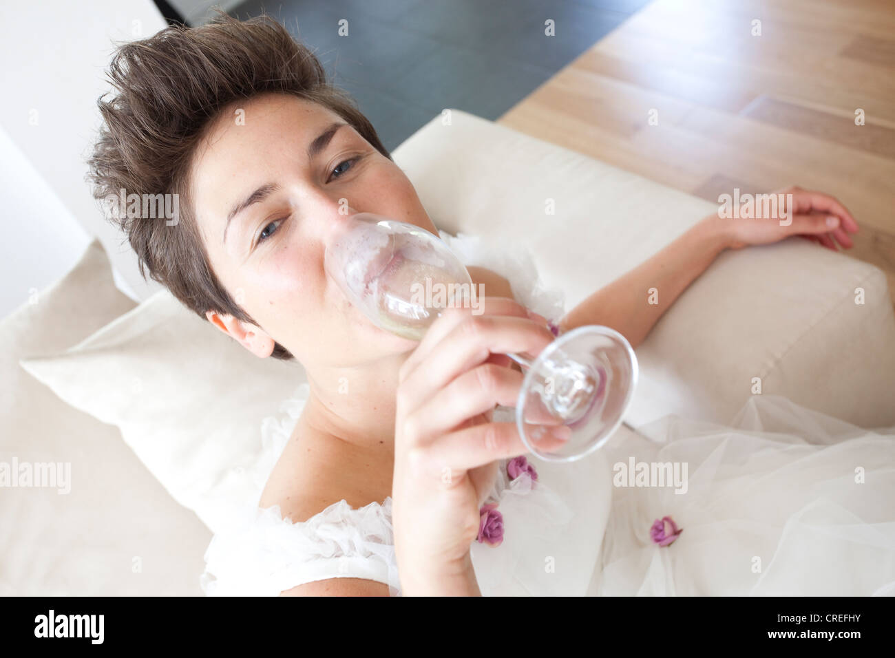 Bride drinking a glass of champagne Stock Photo