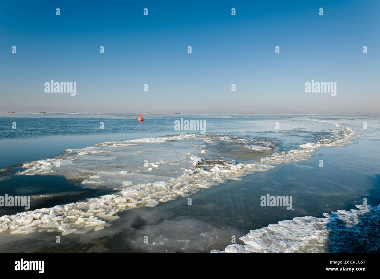 Frozen North Sea with the Hallig Langeness, holm, on the horizon, North