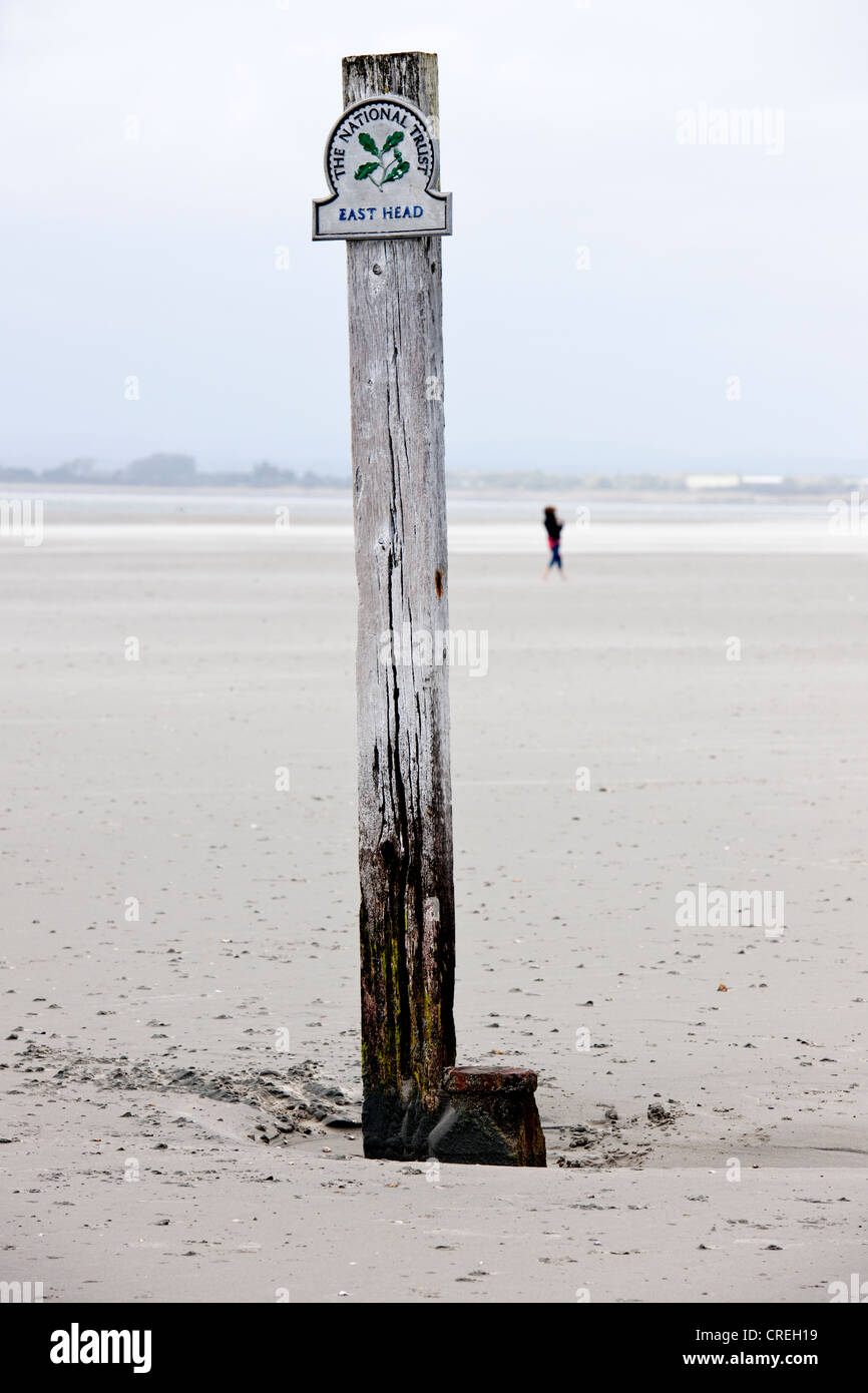 Lone figure on National Trust beach at East Head near west Wittering Beach West Sussex Stock