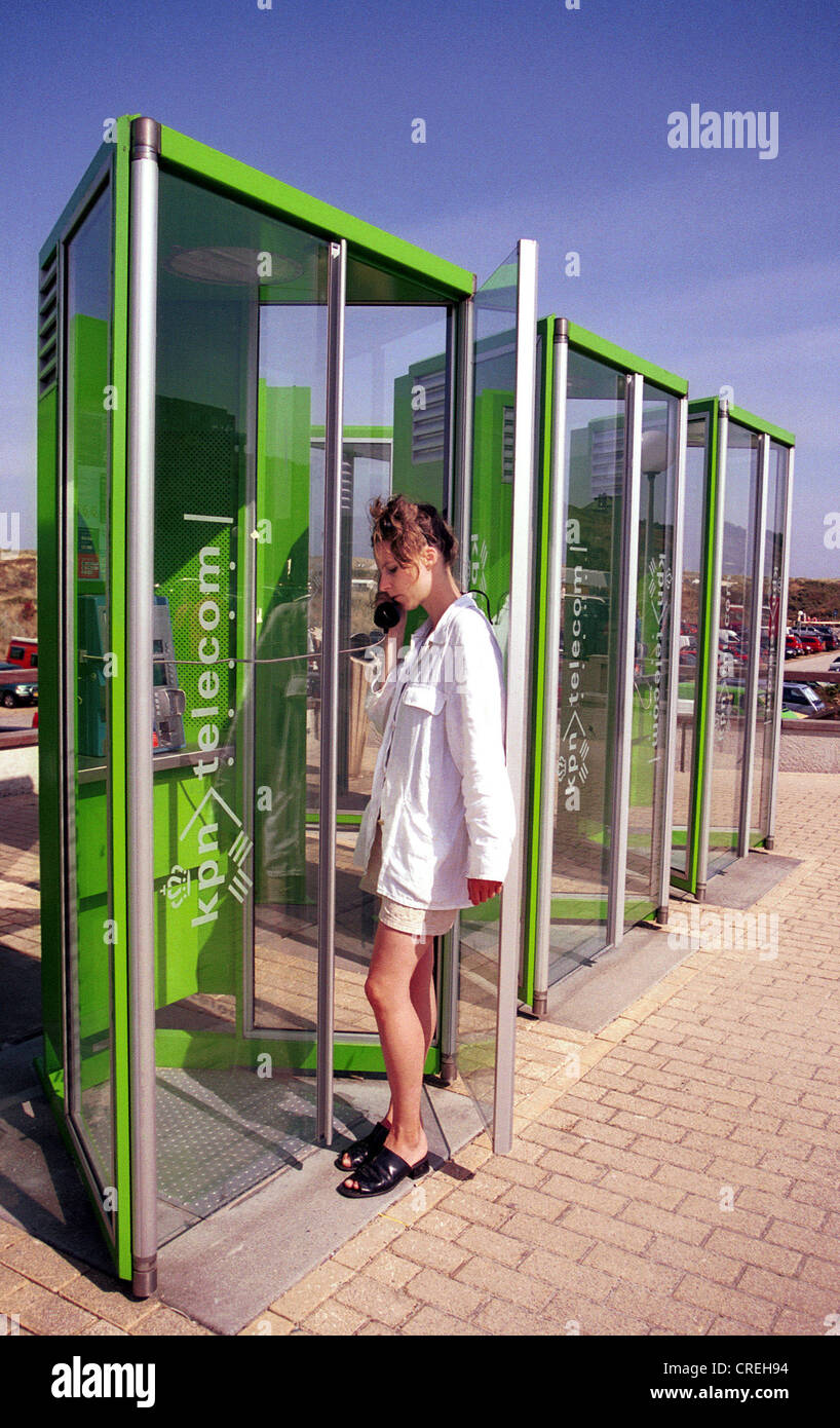 Woman in phone booth KPN, Texel, Texel, Netherlands Stock Photo