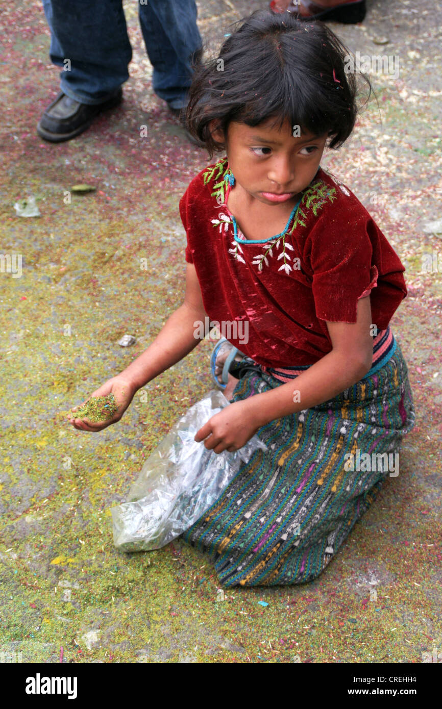 Sad Mayan child with confetti in the middle of a Maya procession in Santiago de Atitlan, Guatemala, Atitlansee, Santiago de Atitlan Stock Photo