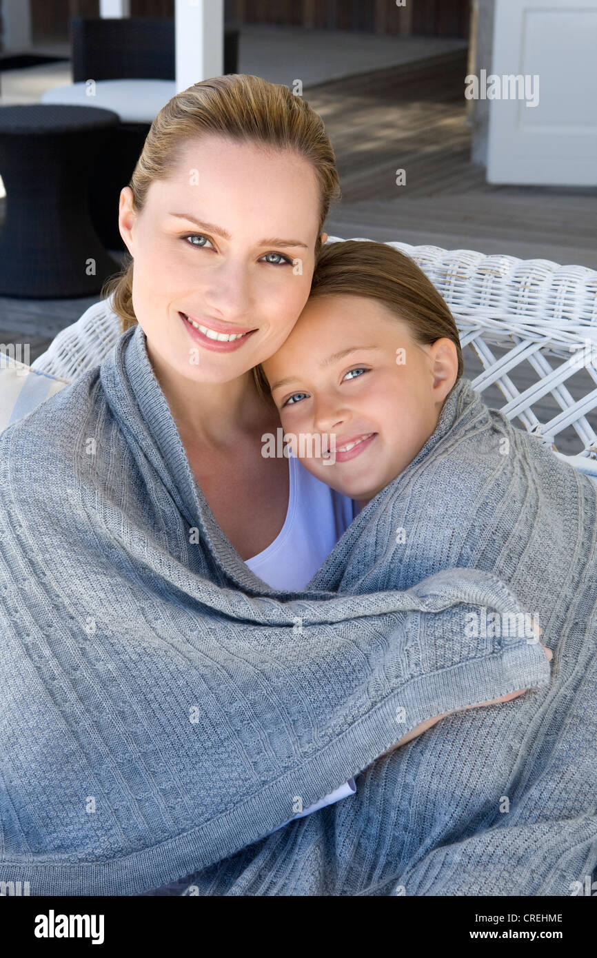 Mother and daughter wrapped in blanket Stock Photo Alamy