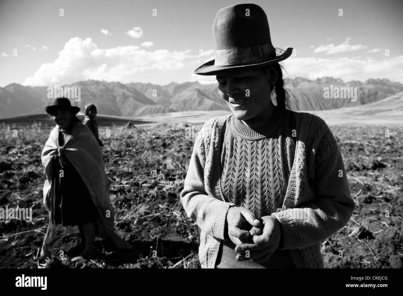 A black and white image of a four women farmers in a field Stock Photo