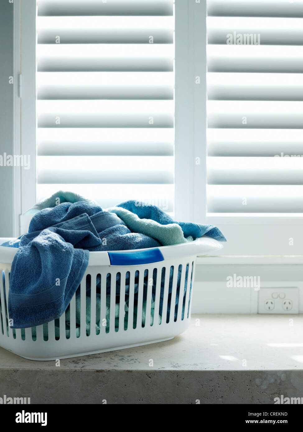 Towels in laundry basket Stock Photo Alamy