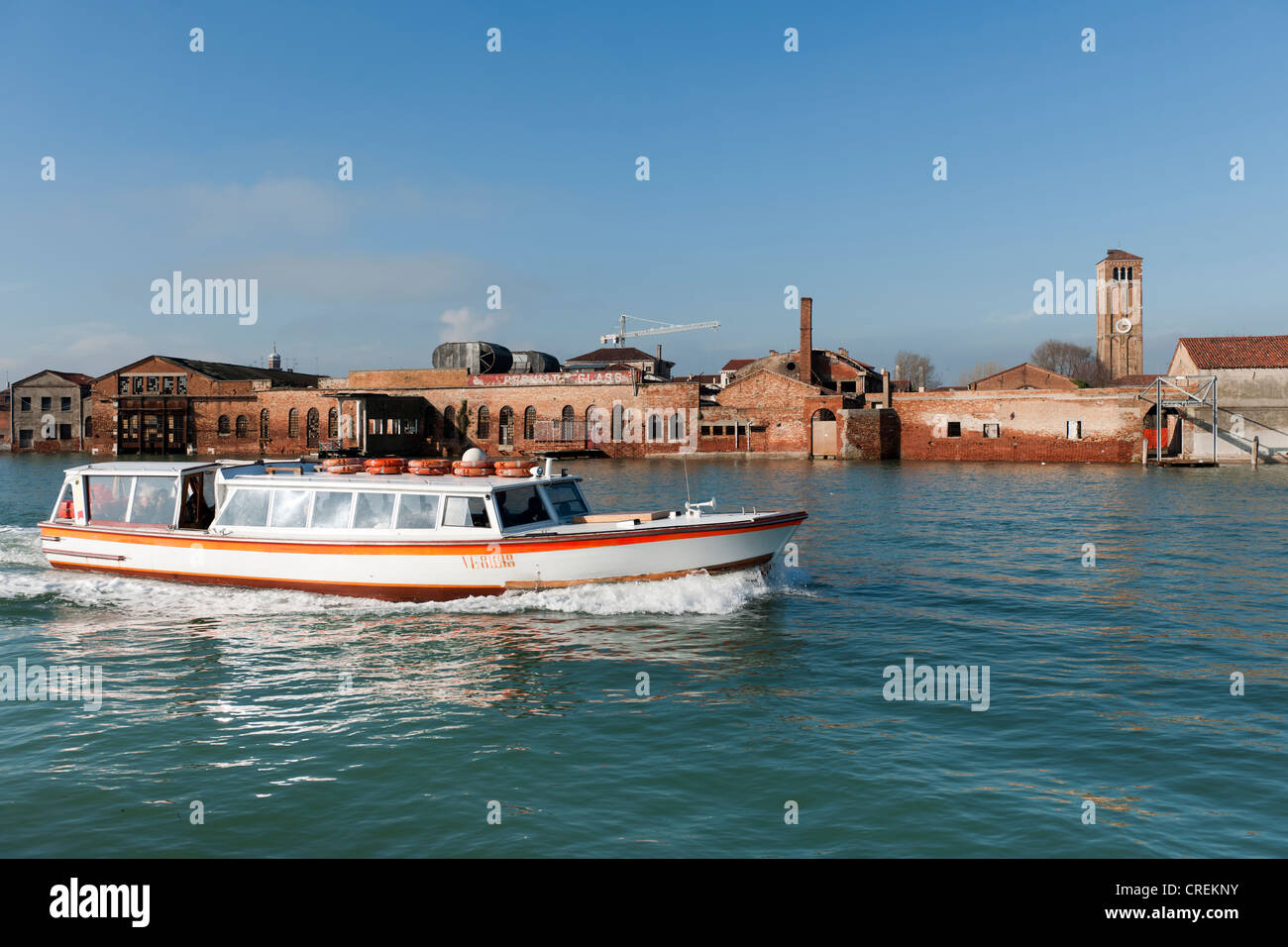 Workshops of the famous glass art on the lagoon island of Murano, a vaporetto in the foreground, Venice, Veneto, Italy Stock Photo