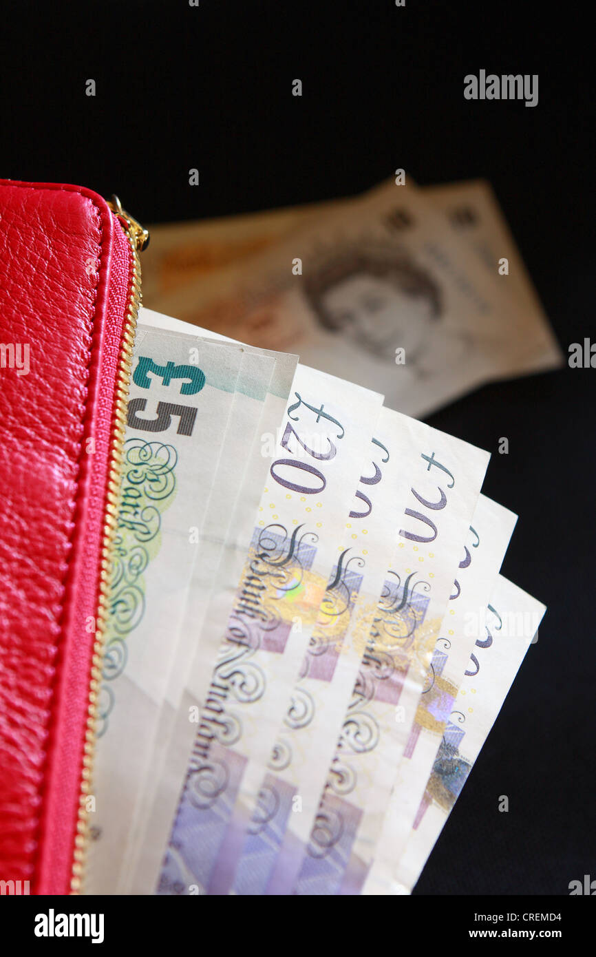 Sterling notes in a lady's purse with two £10 notes visible in the ...