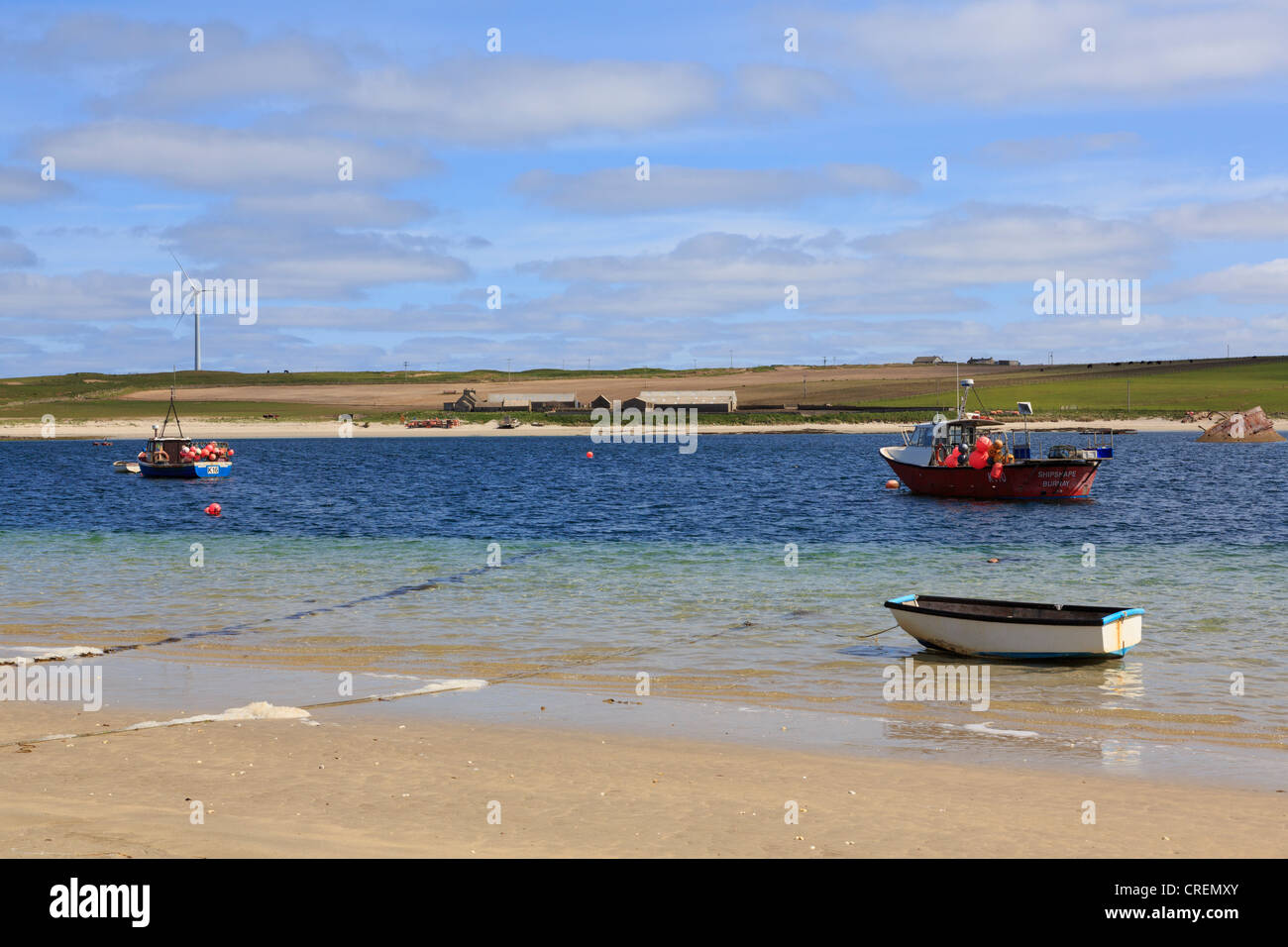 View across Weddell Sound to Burray Island with fishing boats from Glimps Holm beach, Orkney Islands, Scotland, UK, Britain Stock Photo