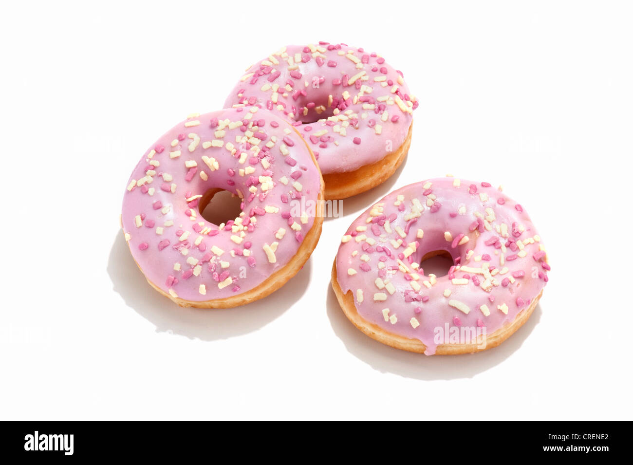 Three ring doughnuts with pink icing Stock Photo